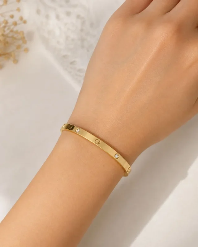 Woman wearing elegant gold plated crystal bracelet
